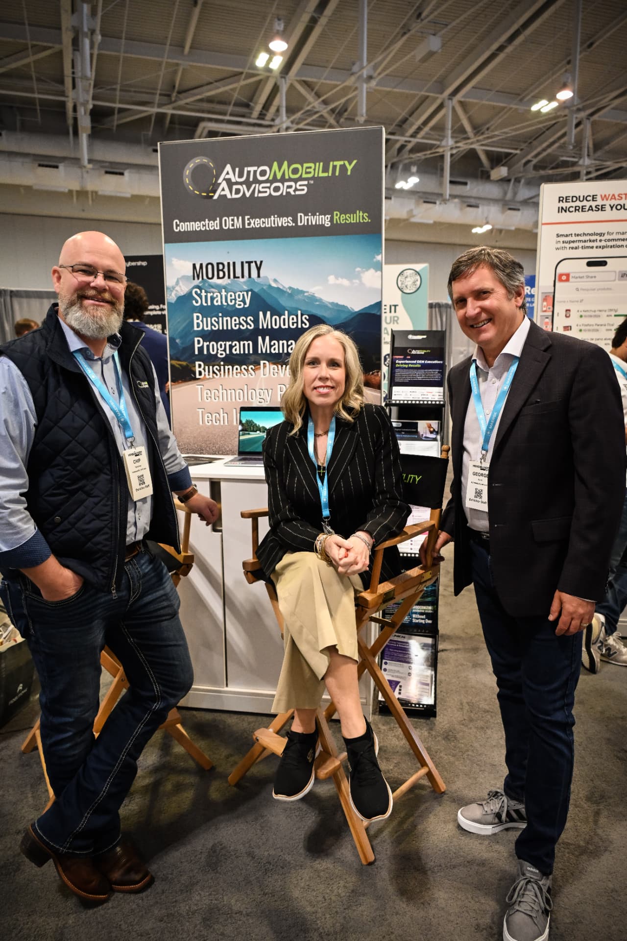 AutoMobility Advisors team members, including Chip Goetzinger and George Ayres, at their trade show booth