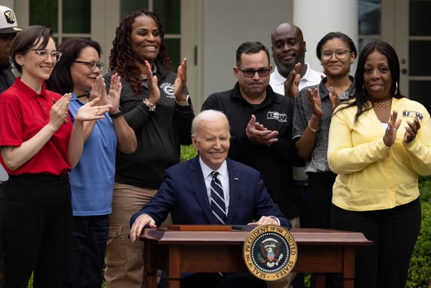 President Joe Biden signing an order raising tariffs on some imports from China