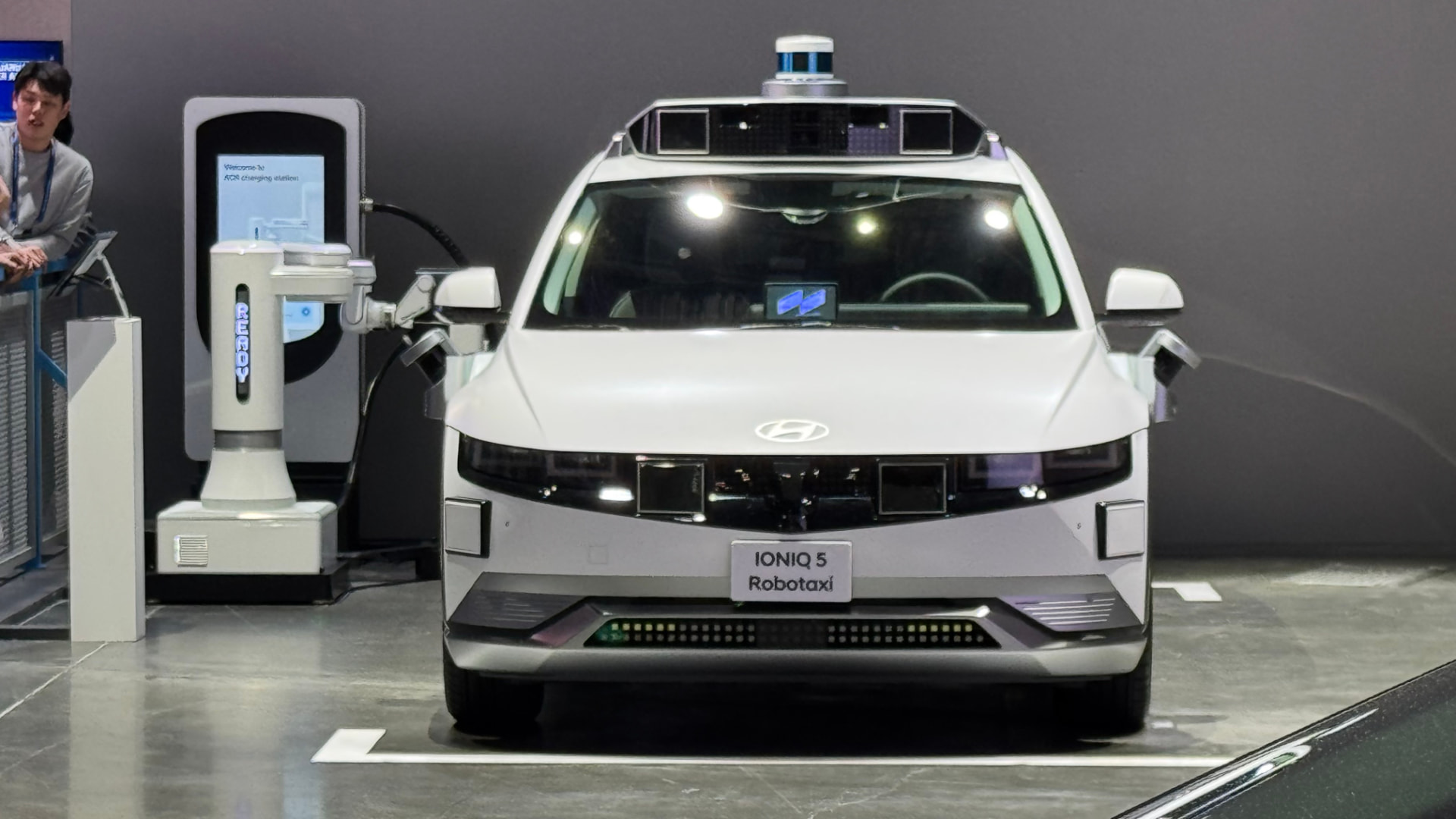 Hyundai’s IONIQ 5 robotaxi connected to an automatic charging arm