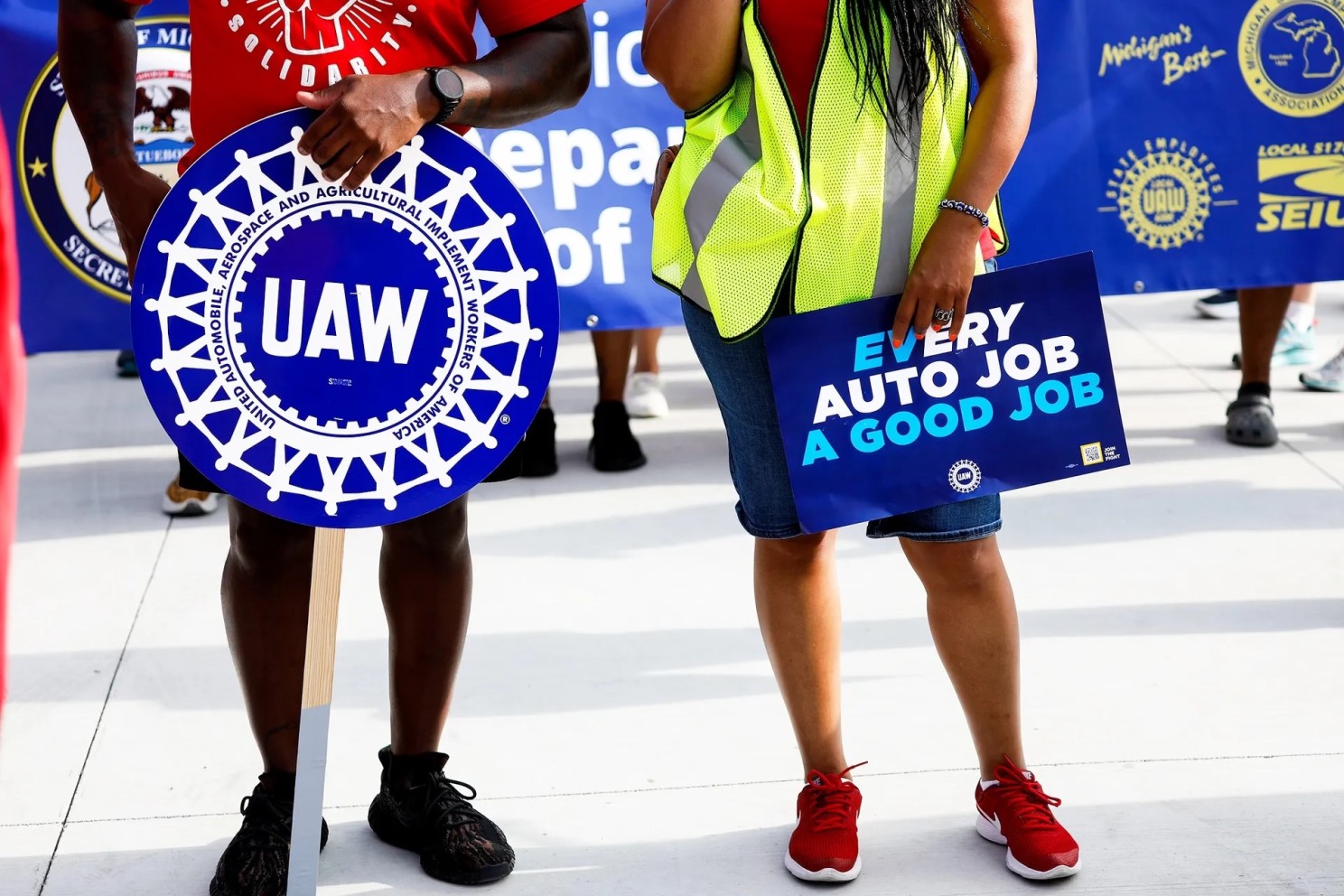 United Auto Workers members and others gather for a rally after marching in the Detroit Labor Day Parade