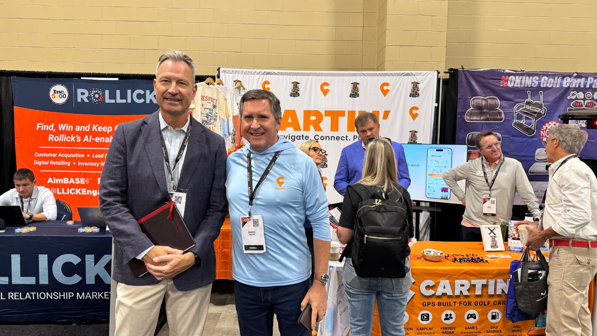 George Ayres with an attendee in front of the Cartin' booth at the GolfCarting Expo
