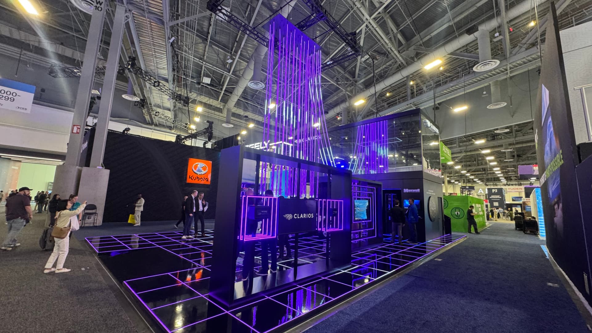The Clarios and Geely stand at CES 2026, lit in purple