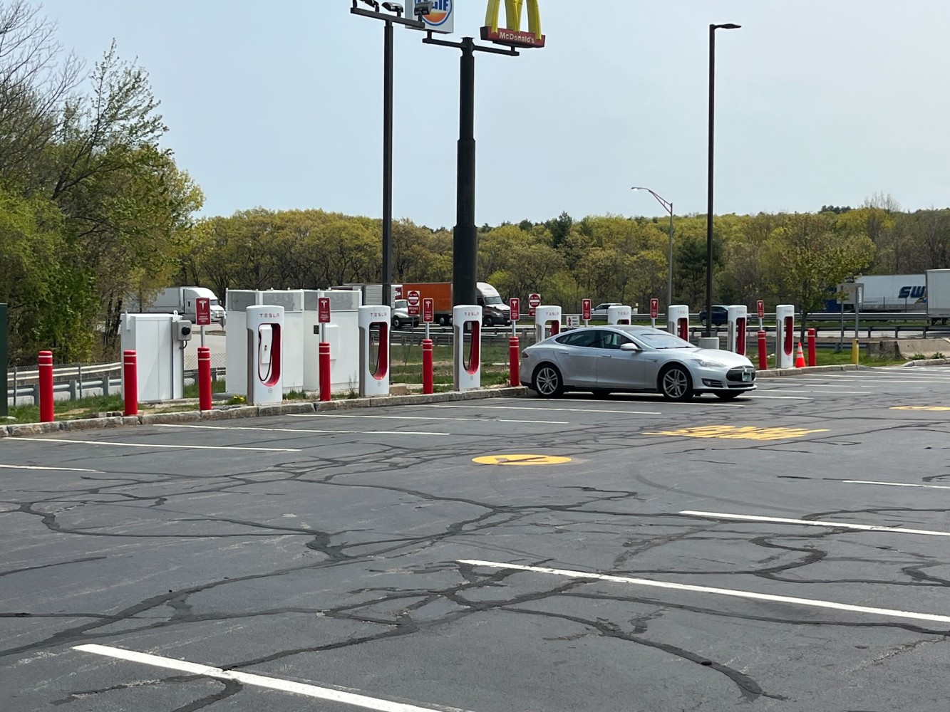 Tesla charging station at the back of a Massachusetts Turnpike parking lot