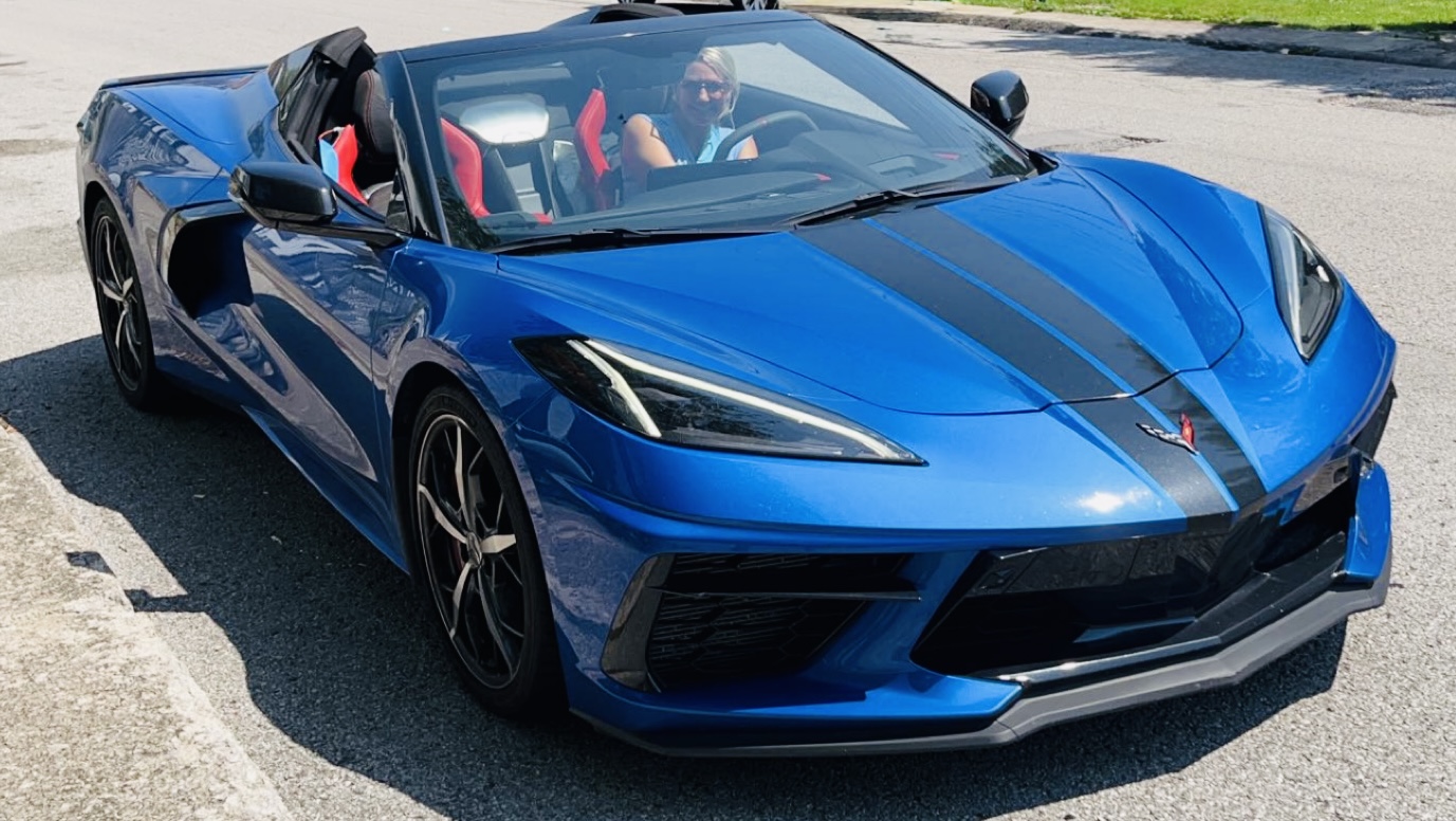 Taking in a sunny day in a Corvette, celebrating her love of driving and automotive innovation.