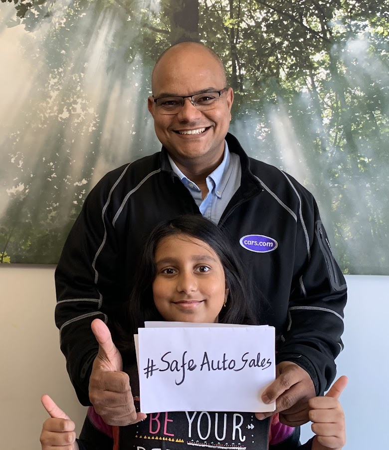 Anoop and his daughter supporting the #SafeAutoSales campaign during the pandemic.