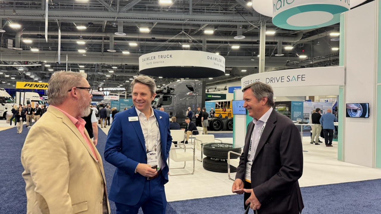 Talking connected trucking with industry colleagues at the Daimler Truck booth, ACT Expo.