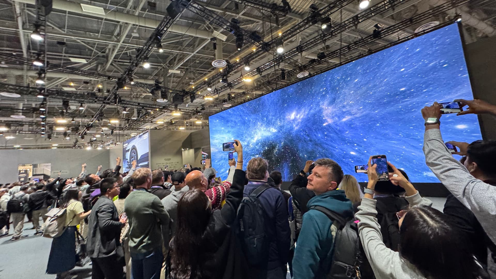 Attendees filming a large screen during a CES 2026 keynote